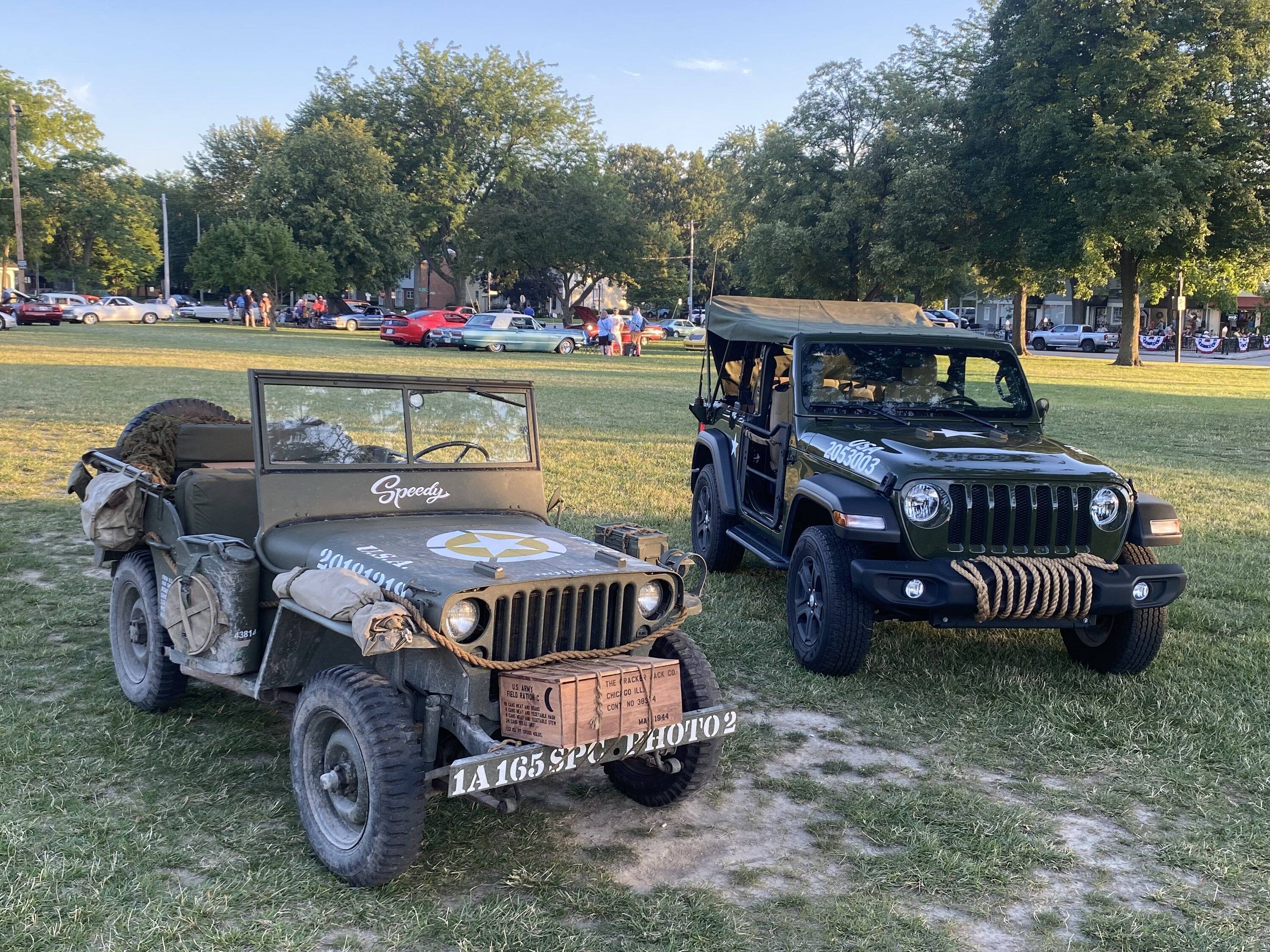 An image of an older and a newer Jeep next to each other.