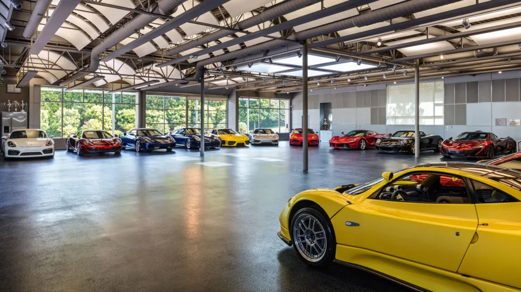 An image of an indoors garage with multiple exotic cars